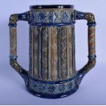 AN ARTS AND CRAFTS TWIN HANDLED STONEWARE CUP decorated with motifs in the manner of Martin Brothers
