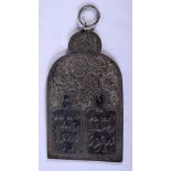 AN ISLAMIC WHITE METAL PENDANT ENGRAVED WITH CALLIGRAPHY AND SYMBOLS. 12.6cm x 7cm