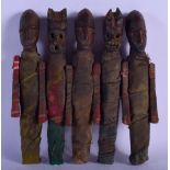 AN UNUSUAL EARLY 20TH CENTURY SOUTH AMERICAN CARVED WOOD TRIBAL SET OF DOLLS modelled in old cloth w