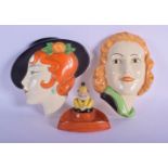 TWO ART DECO PORCELAIN WALL POCKET FACE MASKS together with a similar ashtray. Largest 16 cm x 16 cm