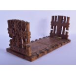 A 19TH CENTURY BAVARIAN BLACK FOREST SLIDING WOOD BOOK RACK formed with foliage and gate posts. 46 c