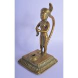 A CHARMING EARLY 19TH CENTURY INDIAN BRONZE FIGURE OF A BOY modelled with a serpent upon a square pl