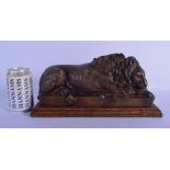 AN EARLY 20TH CENTURY EUROPEAN BRONZE FIGURE OF A SLEEPING LION After the Antiquity, modelled upon a
