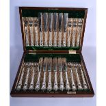 A CASED SET OF ENGLISH SILVER PLATED KNIVES AND FORKS with acanthus capped handles. Box 37 cm x 26 c