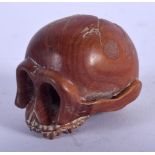 A JAPANESE CARVED WOOD NETSUKE IN THE FORM OF A SKULL. 3.4cm x 4.5cm, weight 15.5g