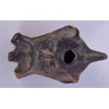 A stone oil lamp with three spouts in the shape male head 11.5 x 7cm.