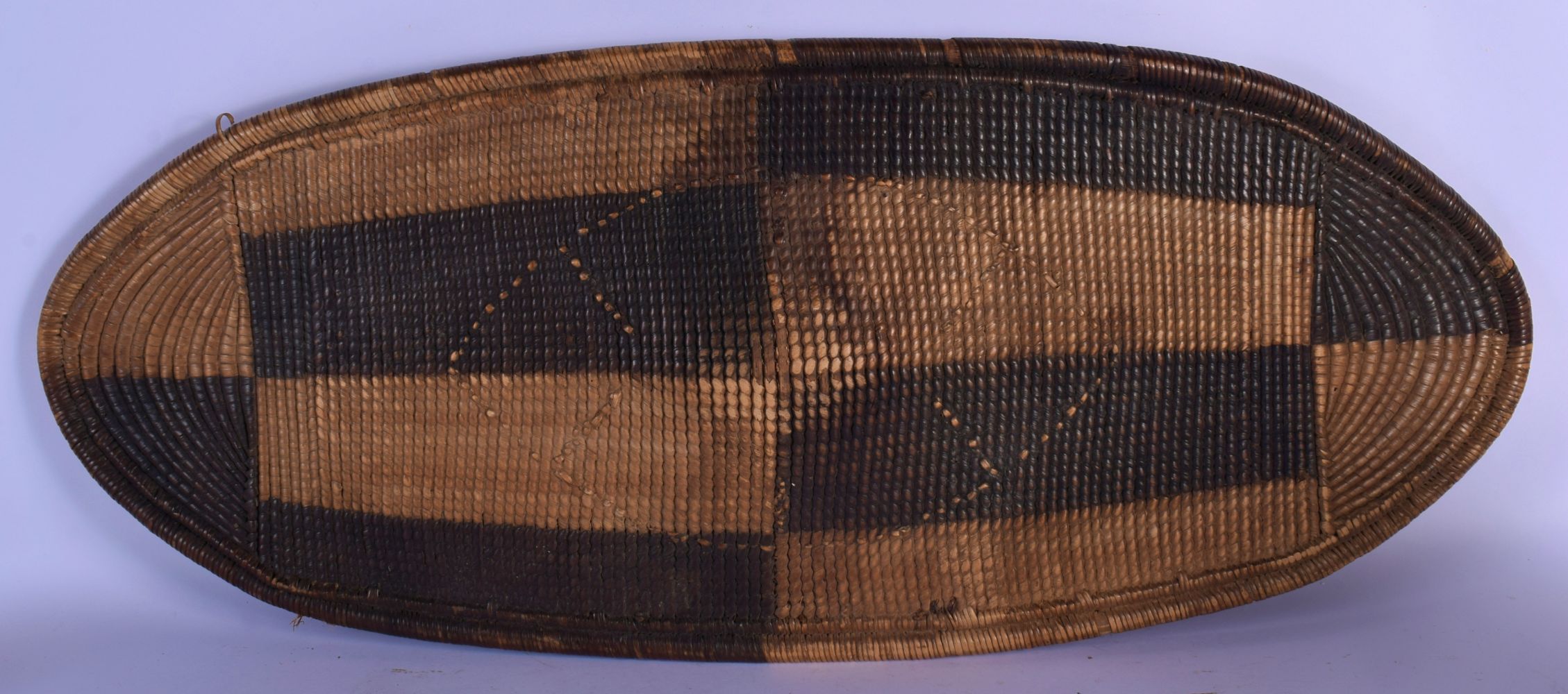 A LARGE EARLY 20TH CENTURY TRIBAL AFRICAN SOUTHSEA ISLANDS WICKER SHEILD with geometric decoration.