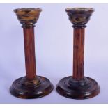 A PAIR OF 1940S BAKELITE FAUX TORTOISESHELL CANDLESTICKS with column stems. 14.5 cm high.