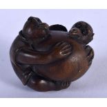 A JAPANESE CARVED WOOD NETSUKE IN THE FORM OF A MONKEY. 3.9cm x 3.3cm, weight 20.6g