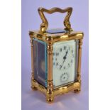 A MINIATURE FRENCH BRASS CARRIAGE ALARM CLOCK. 11 cm high inc handle.