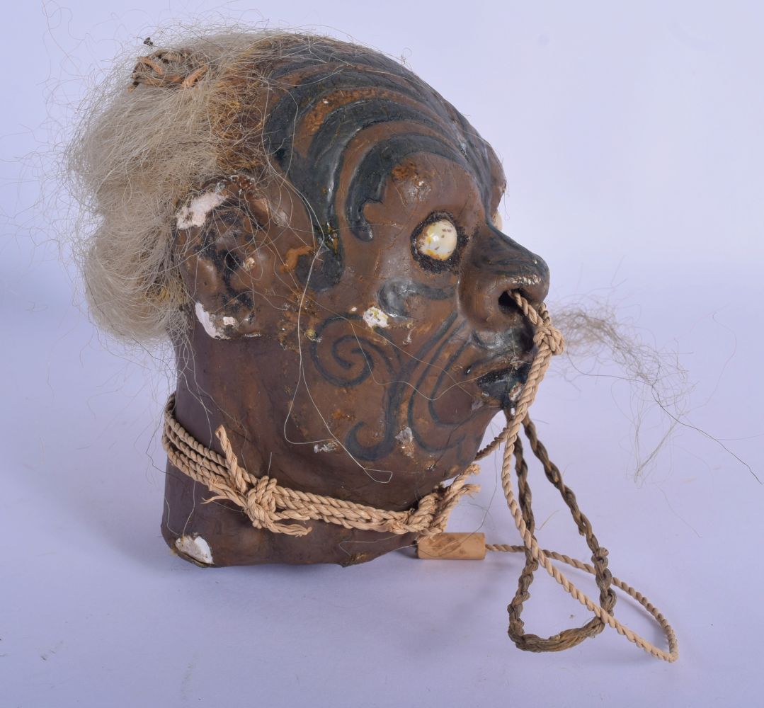 A VERY RARE EARLY 20TH CENTURY TRIBAL WAX TREE GUM SHRUNKEN HEAD decorated with tattoos. 20 cm x 12