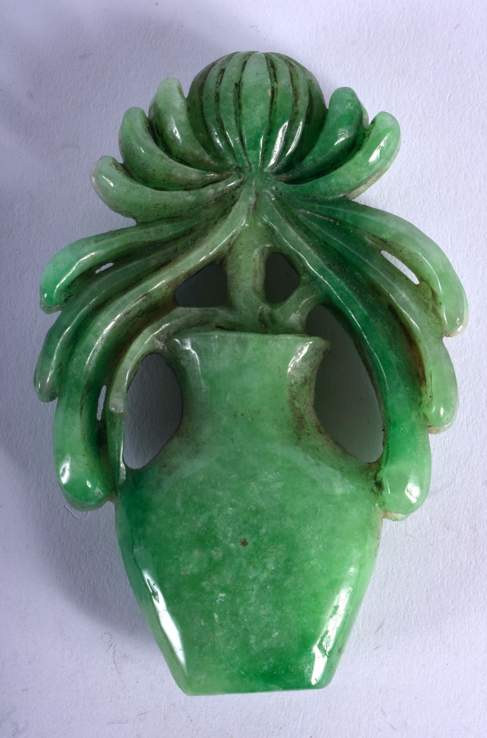 A CHINESE GREEN JADE CARVED FLOWER IN A VASE. 8.9cm x 5.7cm, weight 107.5g