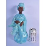 A LARGE FRENCH TURQUOISE ENAMELLED GLAZED POTTERY FIGURE OF A GEISHA modelled holding a lantern. 35