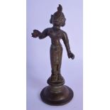AN 18TH/19TH CENTURY INDIAN BRONZE FIGURE OF A BUDDHA modelled with one hand raised, with red paint