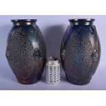 A PAIR OF CARNIVAL GLASS VASES decorated with shell motifs. 30 cm high.