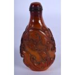 A CHINESE AMBER SNUFF BOTTLE DECORATED WITH DRAGONS. 8.8cm x 4.5cm x 2.9cm, weight 65.2g