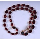 A GEORGIAN 9CT GOLD AND GARNET NECKLACE. Length 42cm, Largest bead 10.9mm long weight 12.9g