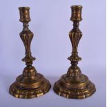 A PAIR OF 19TH CENTURY EUROPEAN BRONZE CANDLESTICKS with a shaped foot. 24 cm high.