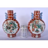 A PAIR OF 19TH CENTURY CHINESE CORAL GROUND PORCELAIN PILGRIM FLASKS Qing, painted with figures upon