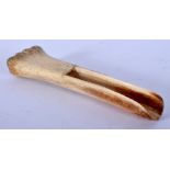 A CARVED BONE TRIBAL SCOOP. 10.5 cm long, weight 21.4 grams.