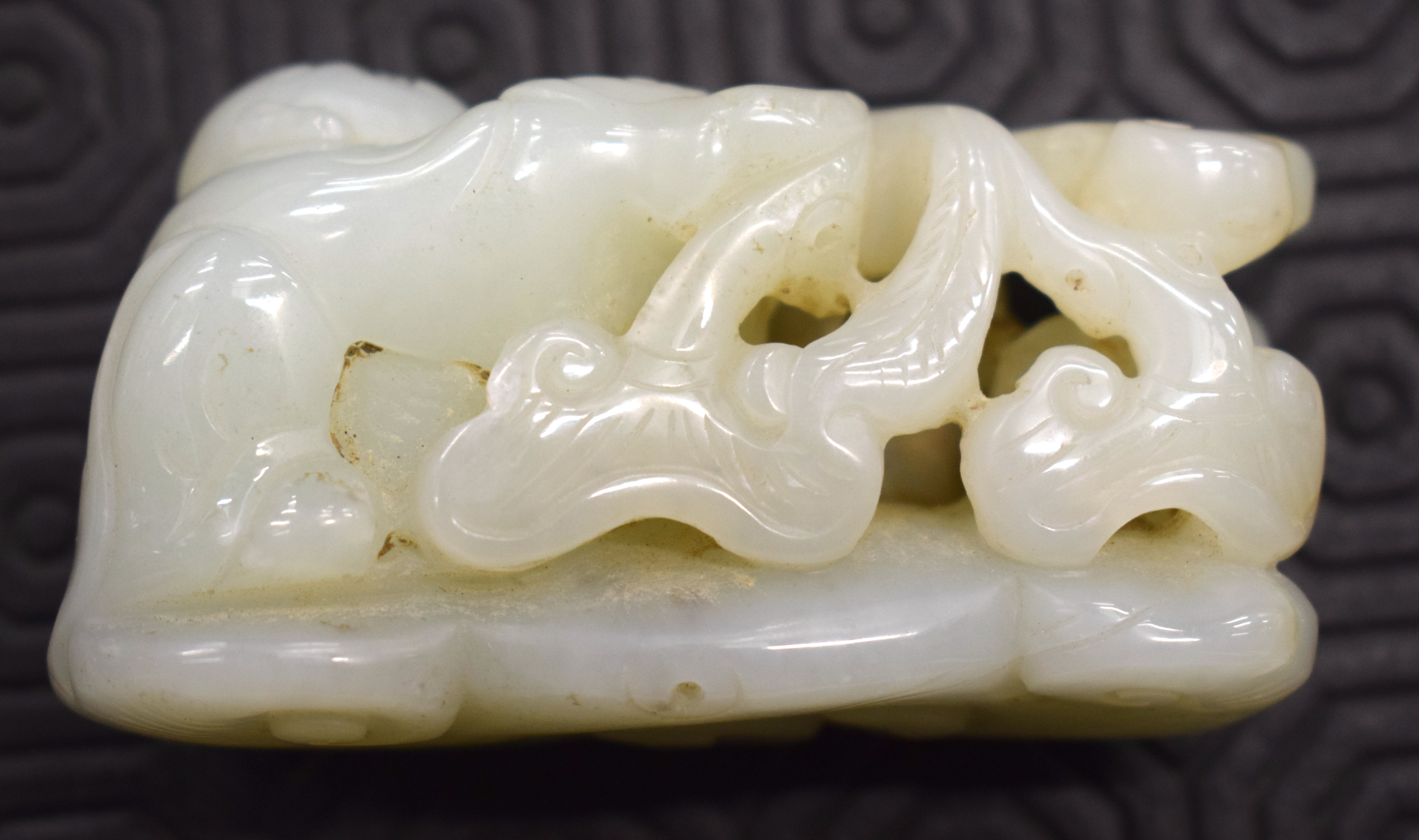 A CHINESE CARVED GREENISH WHITE JADE FIGURE OF A BOY 20th Century, modelled holding lingzhi fungus. - Image 5 of 12