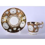 A 19TH CENTURY ENGLISH PORCELAIN TEACUP AND SAUCER Minton or Coalport, painted in the Sevres style.