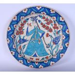 A TURKISH MIDDLE EASTERN IZNIK PLATE painted with a female. 30 cm diameter.