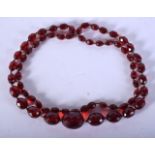 A CHERRY RED BEAD NECKLACE. 45 grams. 86 cm long.