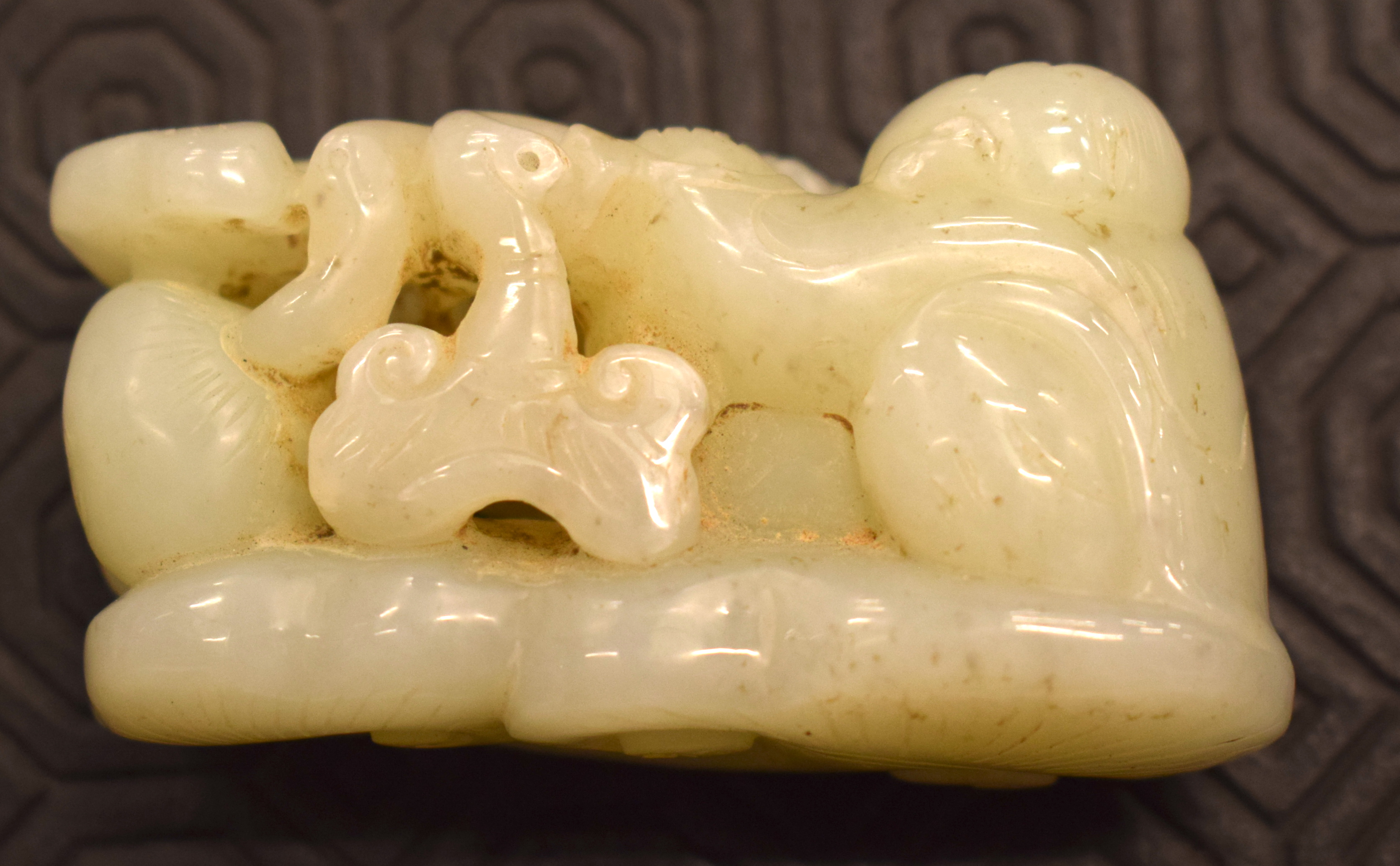 A CHINESE CARVED GREENISH WHITE JADE FIGURE OF A BOY 20th Century, modelled holding lingzhi fungus. - Image 7 of 12