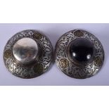 A PAIR OF 19TH CENTURY MIDDLE EASTERN SILVER INLAID BROOCHES decorated with foliage. 136 grams. 9 cm