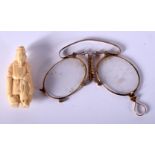 A 19TH CENTURY JAPANESE MEIJI PERIOD CARVED IVORY OKIMONO and a pair of folding glasses. 25.8 grams.