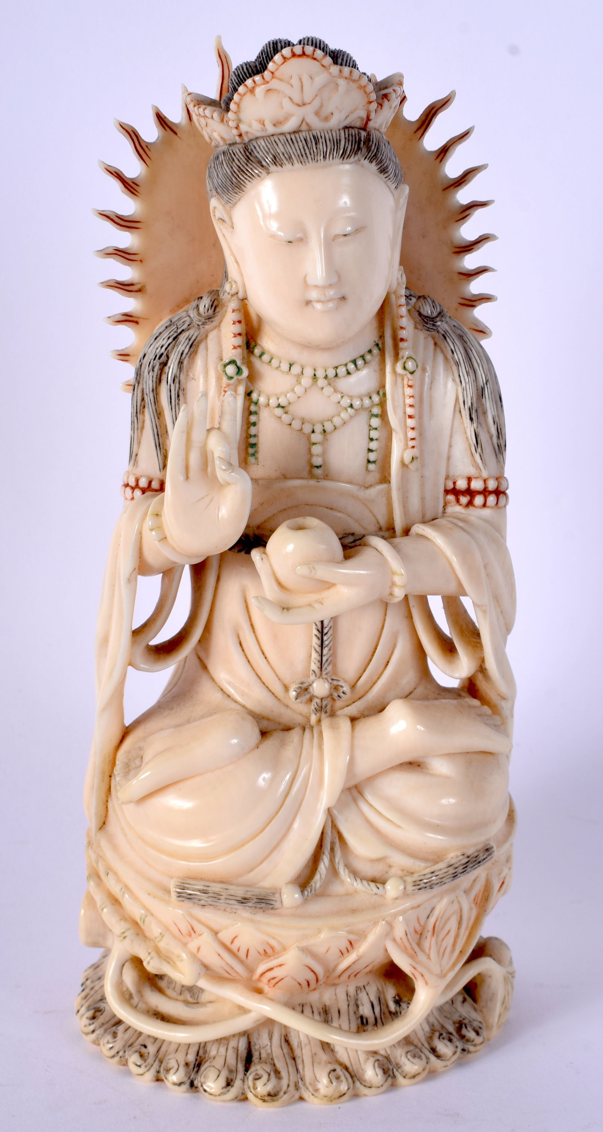 A 19TH CENTURY CHINESE POLYCHROMED IVORY FIGURE OF A SEATED DEITY modelled holding a censer. 16 cm x