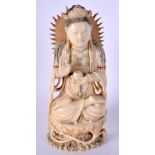 A 19TH CENTURY CHINESE POLYCHROMED IVORY FIGURE OF A SEATED DEITY modelled holding a censer. 16 cm x