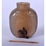A 19TH CENTURY CHINESE CARVED AGATE SNUFF BOTTLE Qing, formed with a male standing holding a coin up