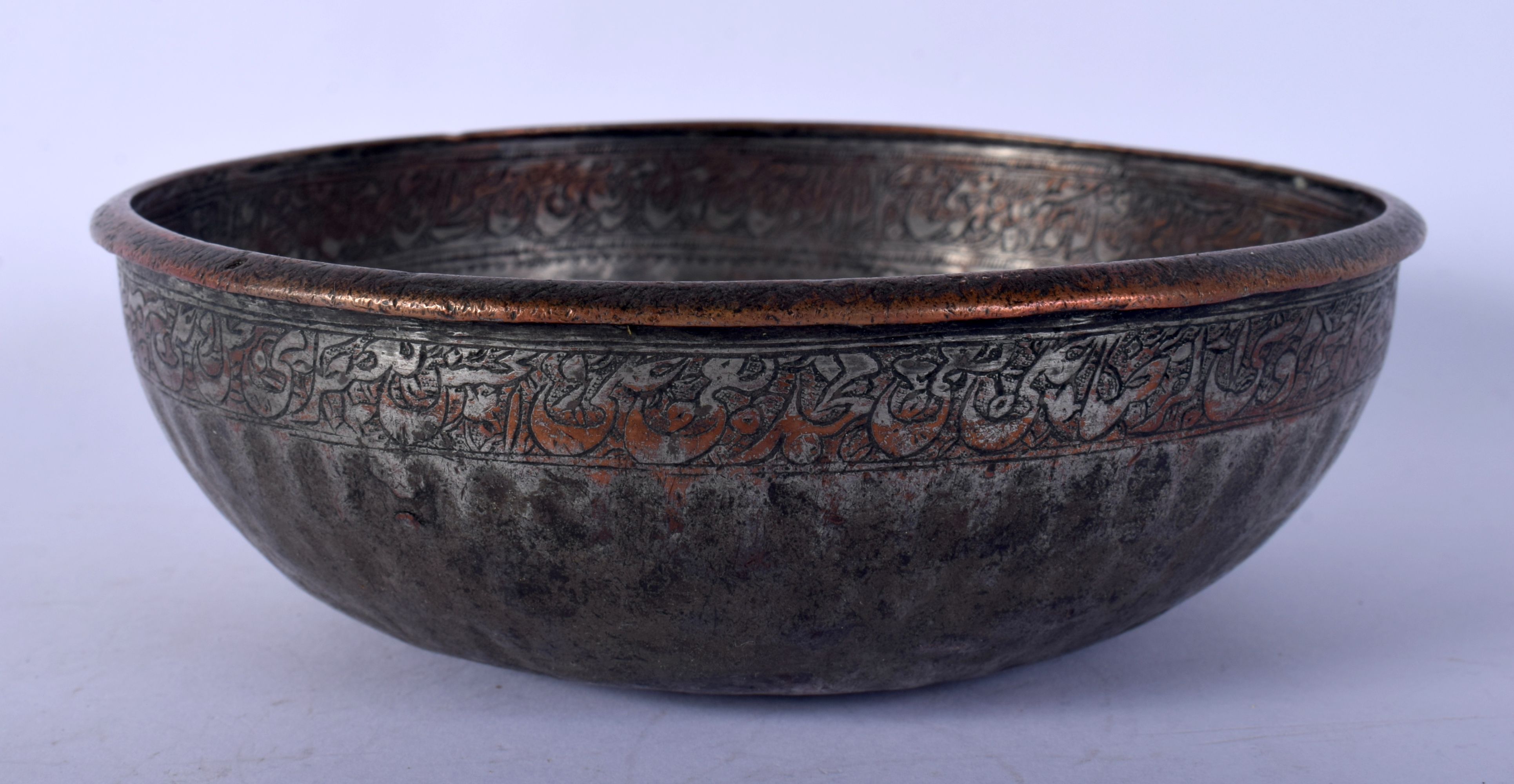 A PERSIAN COPPER ALLOY TINNED CALLIGRAPHY BOWL. 16 cm diameter.