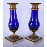 A PAIR OF 19TH CENTURY FRENCH GLASS AND BRONZE VASES with marble bases. 25 cm high.