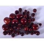 VINTAGE CHERRY AMBER BAKELITE BEADS. 177 grams. Largest 3 cm wide. (qty)