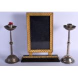 A PAIR OF WMF SILVER PLATED CANDLESTICKS together with a bronze mirror. Largest 38 cm x 23 cm. (3)