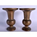 A PAIR OF ANTIQUE INDIAN BRASS VASES. 19 cm high.