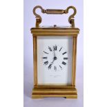 A FRENCH REPEATING BRASS CARRIAGE CLOCK with enamelled dial. 15 cm high inc handle.