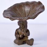 A JAPANESE BRONZE OF A BOY HOLDING A LILY PAD. 6.4cm x 6.1cm, weight 131g