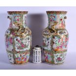 A LARGE PAIR OF 19TH CENTURY CHINESE CANTON FAMILLE ROSE VASES painted with figures within landscape