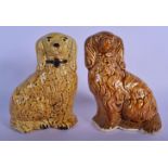 A PAIR OF 19TH CENTURY ENGLISH TREACLE GLAZED POTTERY SPANIELS possibly Rockingham. 16 cm x 8 cm.