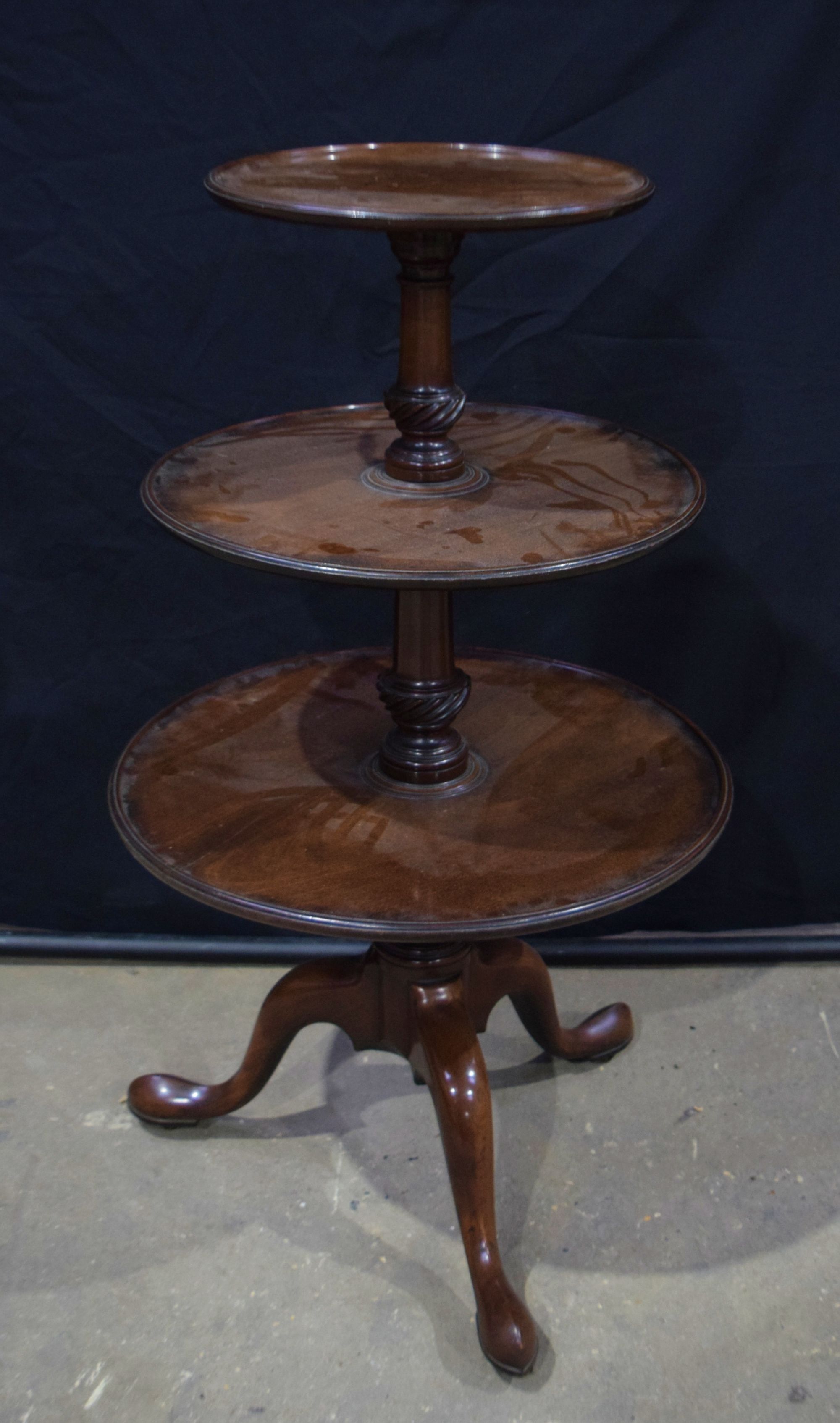 A George III Mahogany dumb waiter C1780, with dished tiers supported on a baluster stem 107 cm , lar