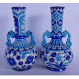 A PAIR OF MIDDLE EASTERN PERSIAN TWIN HANDLED VASES painted with flowers. 26 cm high.