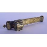 A 19TH CENTURY MIDDLE EASTERN BRASS INKWELL decorated with Kufic script. 24 cm long.