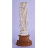 A 19TH CENTURY ANGLO INDIAN CARVED IVORY FIGURE OF A DEITY modelled playing an instrument. 20 cm hig