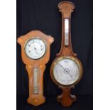 A wooden early 20th century barometer together with another (2)