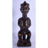 AN UNUSUAL AFRICAN TRIBAL CARVED WOOD FIGURE modelled with inset stud work and scarred face. 25 cm h