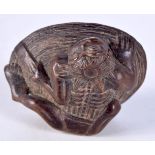 A JAPANESE WOOD NETSUKE CARVED AS A DEMON ON A ROCK. 2.6cm x 4.6cm, weight 23g